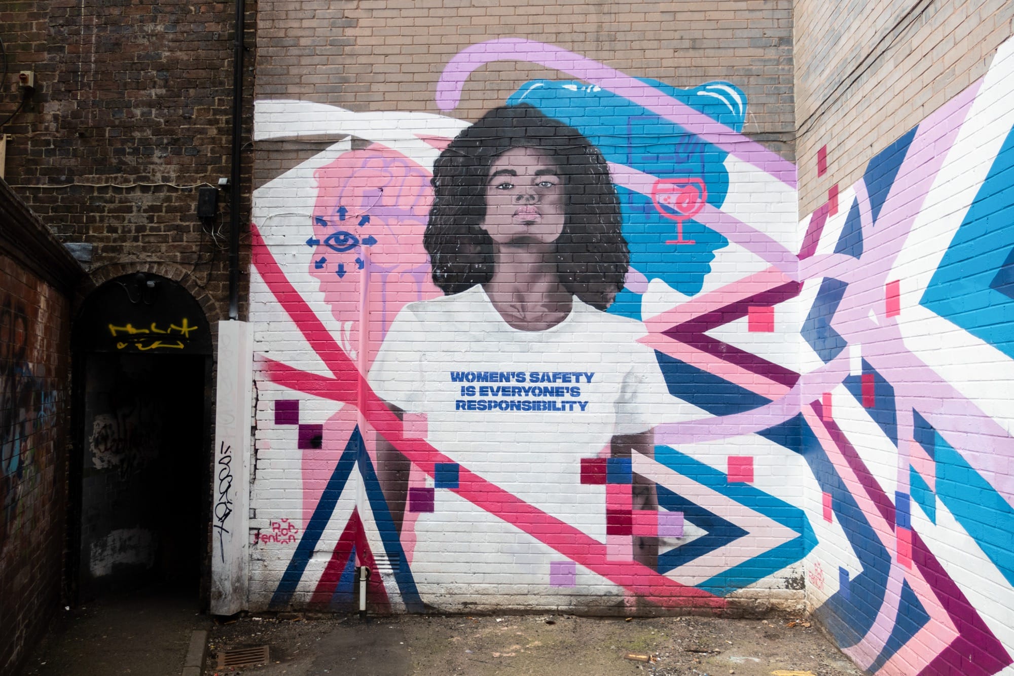 Rob Fenton's mural depicts a young black woman wearing a T-shirt that reads: "Women's safety is everyone's responsibility." Surrounded by colorful graphics