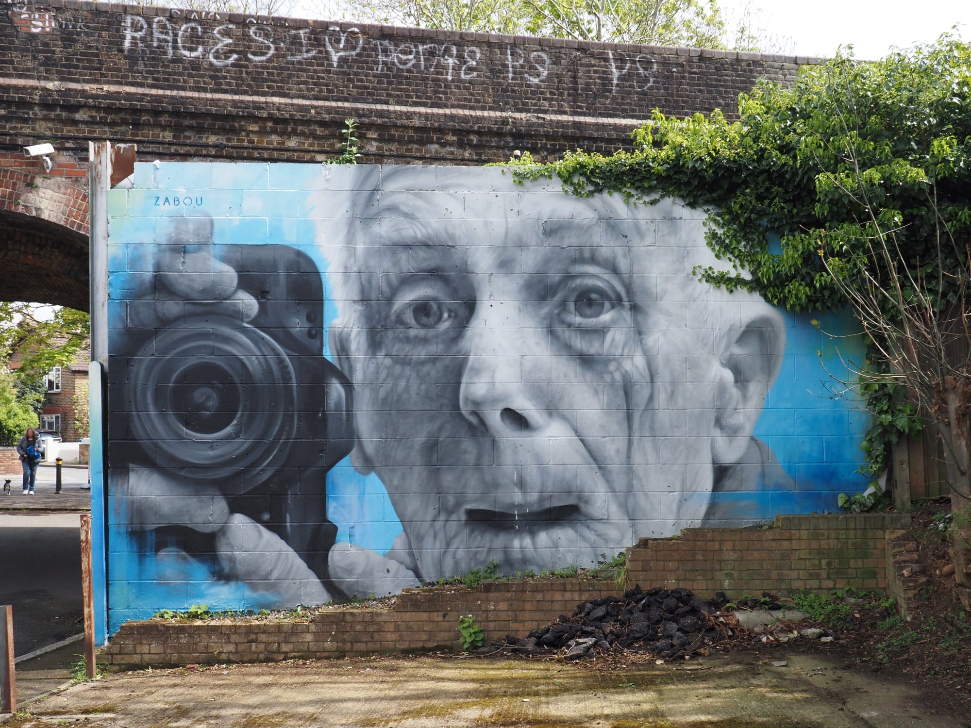 Mural of Gordon Gibbens holding a camera by Zabu