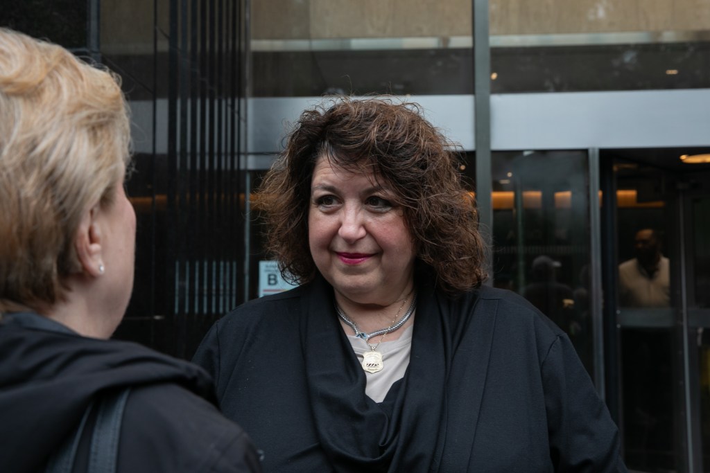 Marianne Pizzitla, the city's retirement leader, speaks to demonstrators opposing the Medicare Advantage plan.