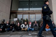Gender Liberation Movement and ACT UP protesters block the entrance to the Department of Health and Human Services while protesting the Trump administration's plan to cut federal funding to clinics that provide care for transgender youth.