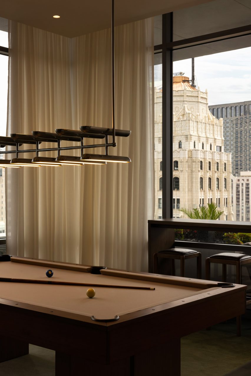 A brown pool table with the Chicago skyline behind it