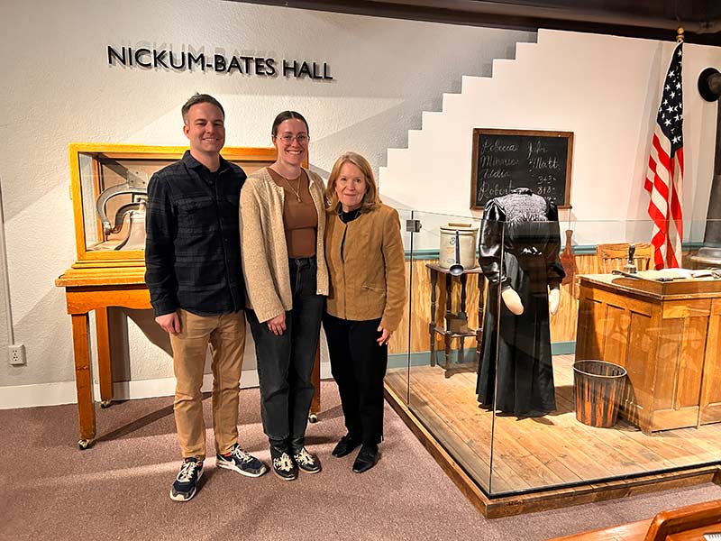 Jeff Kerr (left), Chloe Doucette (center), and Callie Abbondet (next to the Rebecca Mitchell exhibit at the Museum of Idaho). | Rhett Nelson, EastIdahoNews.com