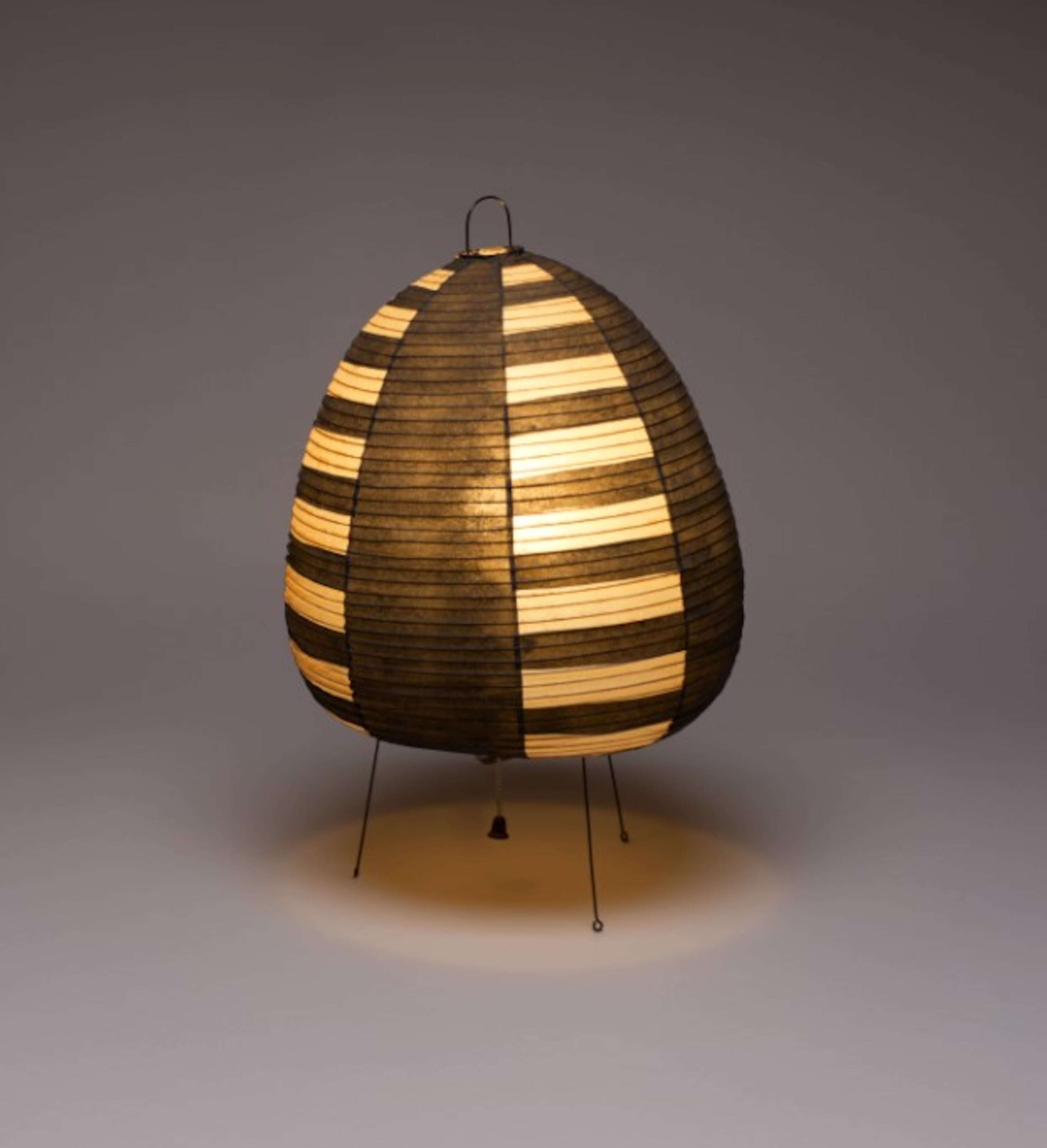 The Akari (Model 1A) lamp, designed by Isamu Noguchi in 1954, is on display at the High Museum. This lamp is made of natural mulberry paper with black painted panels, a fine bamboo and handprint metal frame, and original electrical components. (Courtesy of High Museum)
