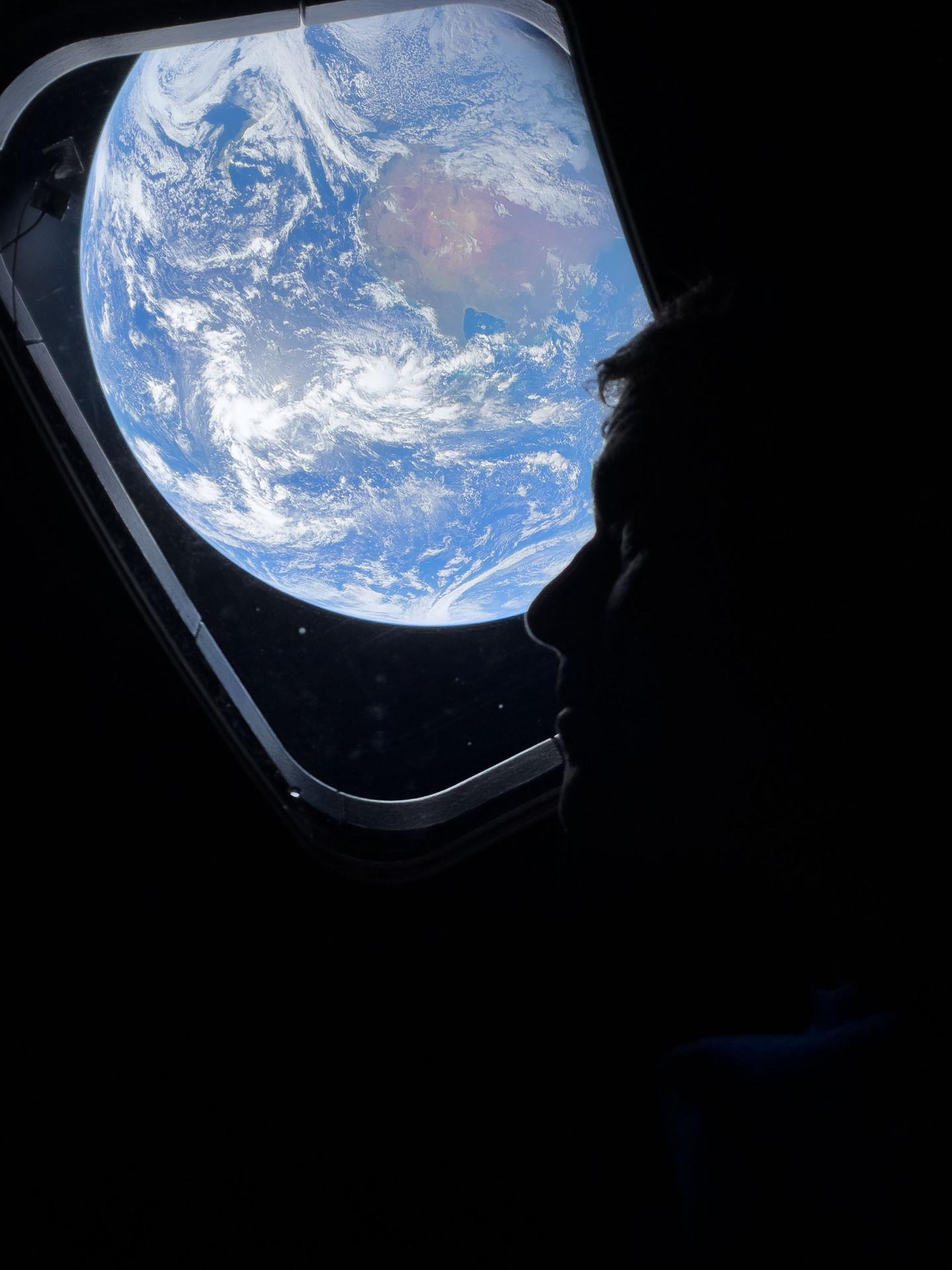 Photo from Artemis II: NASA astronaut and Artemis II commander Reed Wiseman looks back at Earth from one of the Orion spacecraft's main cabin windows as the crew moves towards the moon.
