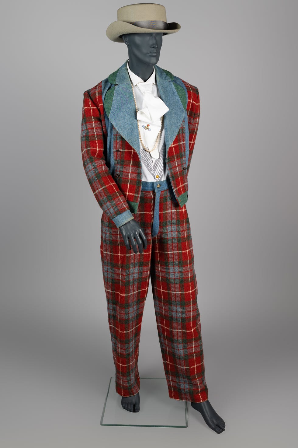 A mannequin wearing a stylish plaid suit with a wide-brimmed hat