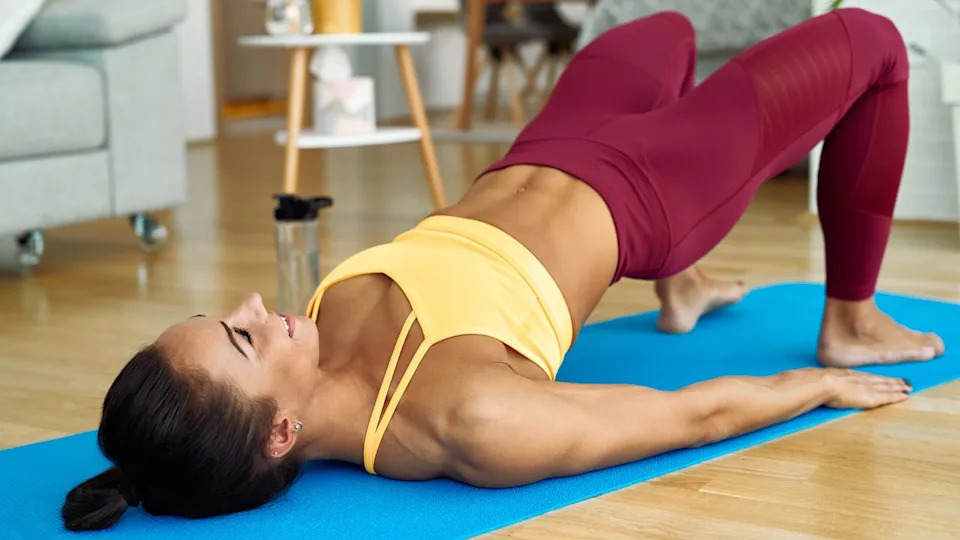 A photo of a woman doing a glute bridge.