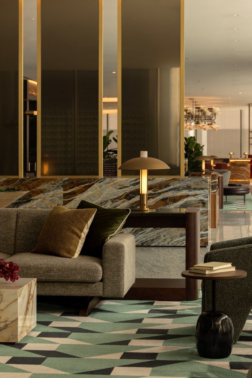 Office amenity lounge with geometric carpet and mid-century furniture